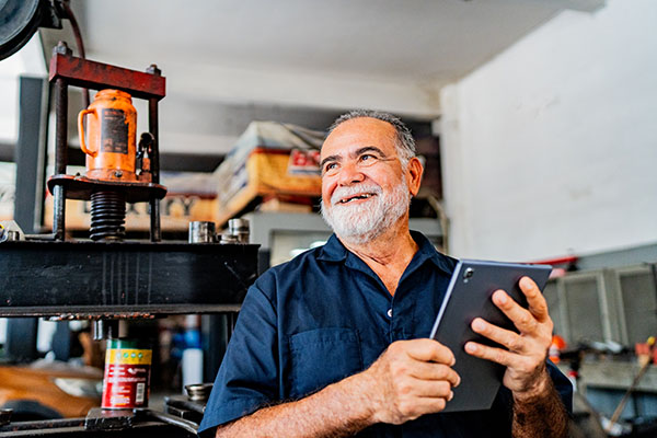 Senior mechanic working on a tablet
